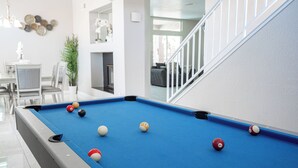 A pool table with balls in a modern indoor setting. - Serene 5-bedrooms 3 bathrooms House with Pool in North Las Vegas (North Las Vegas)