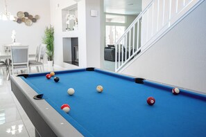 A pool table with balls in a modern indoor setting. - Serene 5-bedrooms 3 bathrooms House with Pool in North Las Vegas (North Las Vegas)