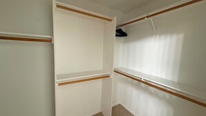 A room with a white wardrobe, a wooden shelf, and a hanging space. - Tutus House 🌞 Coldwater Springs, Avondale, AZ (Avondale)