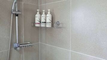 Shower, hair dryer, towels, shampoo
