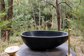A black basin with a gold faucet in a forest setting. - Luxury Nature-Surrounded Estate House With Pool (Theresa Park)