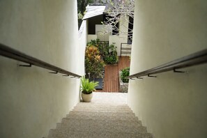 A staircase leading to a gated entrance with a potted plant at the bottom. - Roberto Villas, A Short Scooter Drive to The PadangPadang and Bingn Beach (Pecatu)
