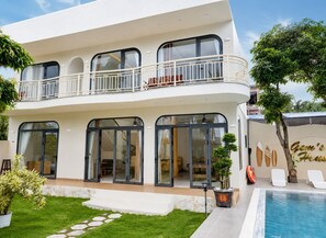 A two-story house with a balcony, a swimming pool, and a sign that reads 'Gem's House'. - Gem's House (Mui Ne)