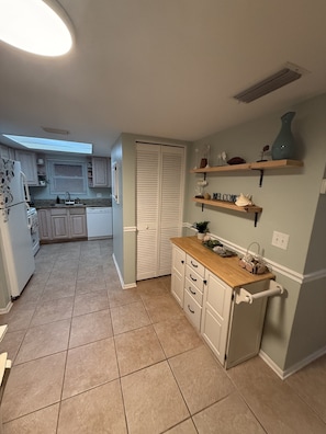 A compact kitchen with a built-in oven, a sink, and a window above the countertop. - Daytona Intercostal Retreat Home  3 Beds (Port Orange)