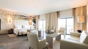 A hotel room with a bed, a desk, a sofa, and a dining table.