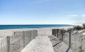 A beach pathway leading to the ocean, flanked by wooden fences. - Oceanside,Pool,Skee-ball,Nintendo,Pets,Arcades (Ocean City)