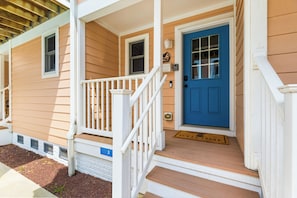 A two-story house with a blue front door, white railings, and a number '3' sign. - Oceanside,Pool,Skee-ball,Nintendo,Pets,Beach Gear (Ocean City)