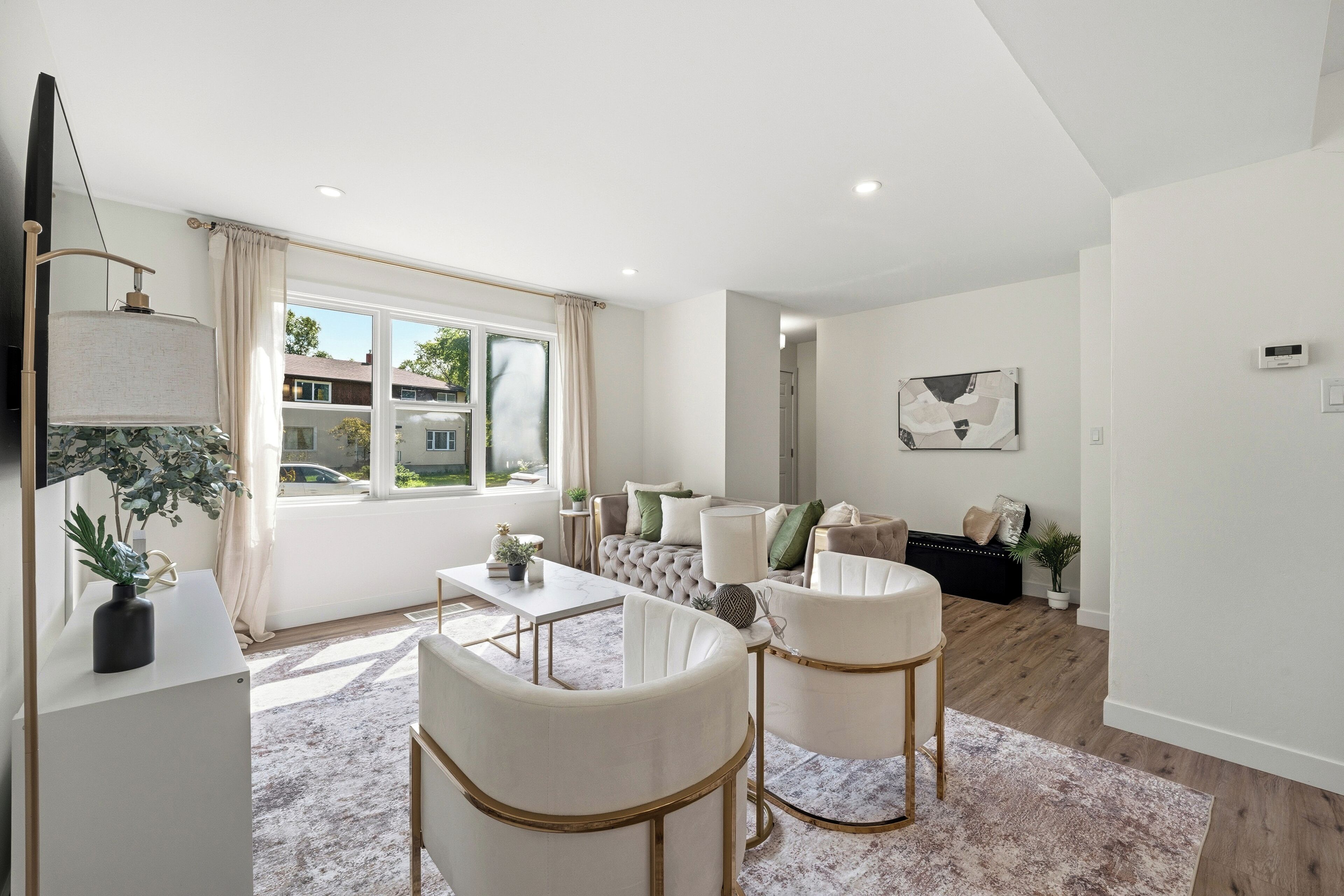 A modern living room with a sofa set, a coffee table, and a dining table.