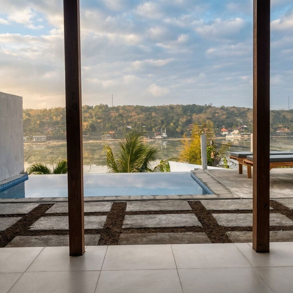 A pool area with a view of a hilly landscape and a distant building.