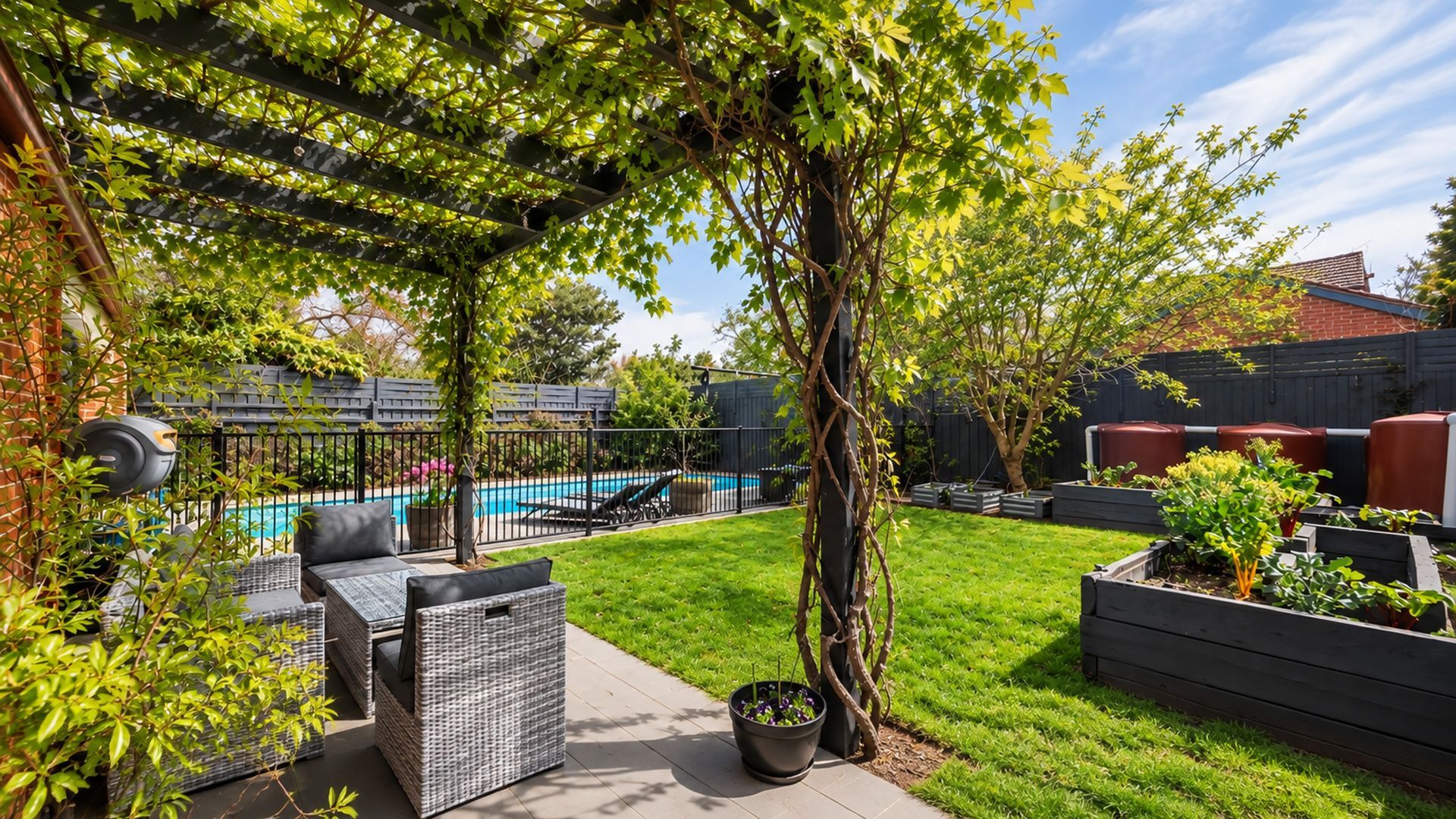 A backyard with a pool, outdoor furniture, a pergola, and raised garden beds.