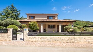 A two-story house with a stone facade, a tiled roof, and a paved driveway. - Villa Terra With Pool & Sauna Near Rabac (Labin)