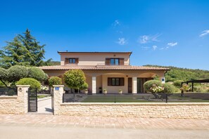 A two-story house with a stone facade, a tiled roof, and a paved driveway. - Villa Terra With Pool & Sauna Near Rabac (Labin)