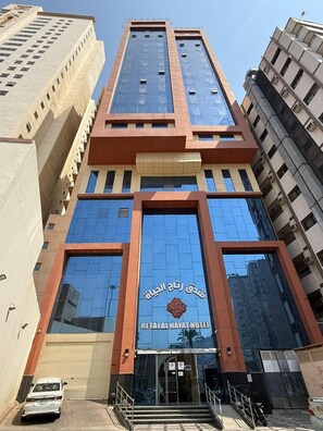 A hotel with a modern facade, large glass windows, and a prominent entrance.