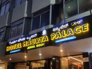 A hotel sign with 'HOTEL MAURY PALACE JEWEL ROCK' and 'Multi Cuisine Restaurant' written in bright, illuminated letters. - Hotel Maruya Palace (Mysore)