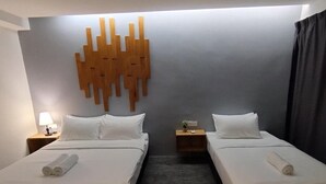 A hotel room with two beds, a wall-mounted light fixture, and a small bedside table with a lamp. - Swing & Pillows @ CIQ Johor Bahru (Johor Bahru)