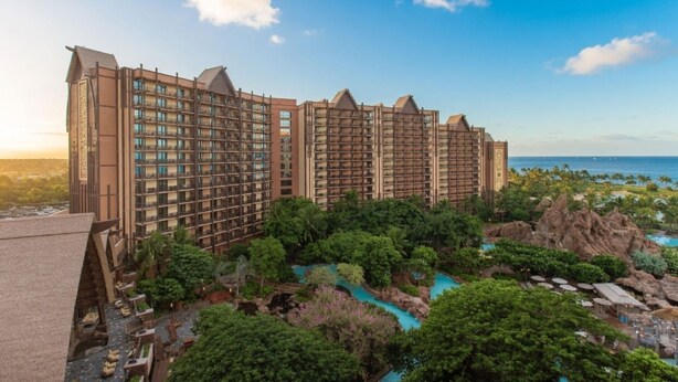 A large hotel with multiple floors, a pool area, and a view of the ocean. - Ko Olina | Couples Disney Retreat | Lagoon + Pool (Kapolei)