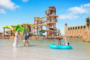 A water park with a large water slide structure and a pool area.