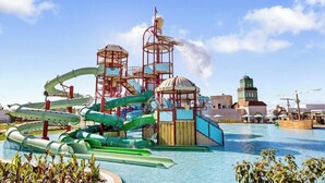 A water park with multiple slides and a pool.