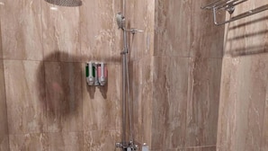 A modern bathroom with a shower, toilet, and sink. - Gemma Hotel Balige (Balige)