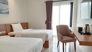 A hotel room with two beds, a desk with a chair, and a window with curtains. - Gemma Hotel Balige (Balige)