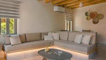 A modern living room with a sectional sofa, a coffee table, and a wall-mounted light fixture.