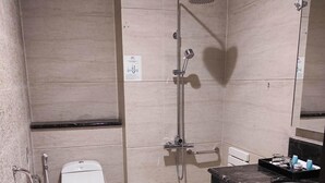 A bathroom with a toilet, a shower, and a sink. - Beth Kasegaran Theresia (Megamendung)