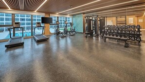 A gym with treadmills, weight machines, and dumbbells. - Hilton Garden Inn Guangzhou Baiyun Airport (Guangzhou)