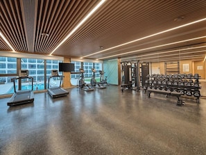 A gym with treadmills, weight machines, and dumbbells. - Hilton Garden Inn Guangzhou Baiyun Airport (Guangzhou)
