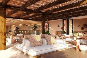 A modern living area with a wooden ceiling, a sofa set, and a dining area in the background. - Costa Borgo Ragusa (Ragusa)
