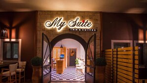 An entrance to a hotel with a checkered floor, a reception desk, and a sign that reads 'My Suite INN & SUITES.' - My Suite Boutique Hotel Parga (Parga)