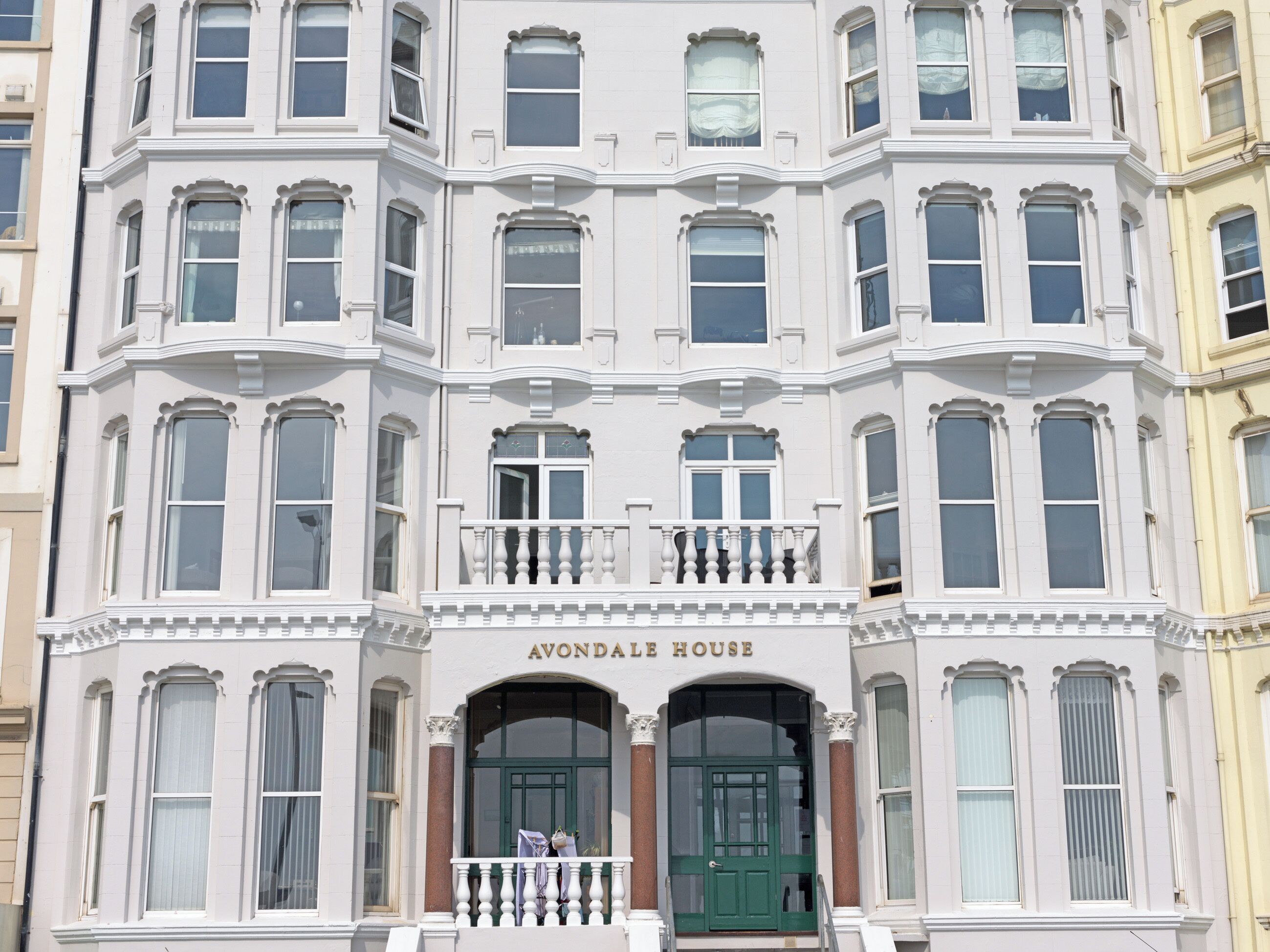 A multi-story building with a prominent entrance labeled 'AVONDALLE HOUSE.'