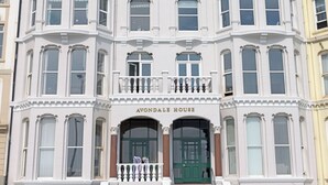A multi-story building with a prominent entrance labeled 'AVONDALLE HOUSE.'
