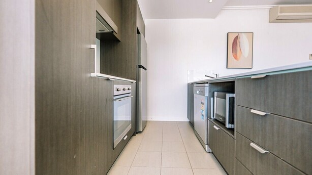 A modern kitchen with built-in appliances, a dishwasher, and a microwave. - Two Bedroom Sanctuary in the Valley (Fortitude Valley)