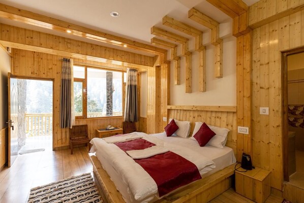 A wooden-paneled room with a bed, a bench, and a window.