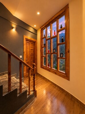 A wooden staircase with a handrail leading to a door. - Sunshine By Nature Crest  (Jibhi)