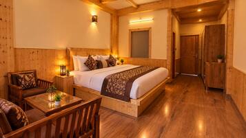 A wooden-paneled room with a bed, a table, and a chair.