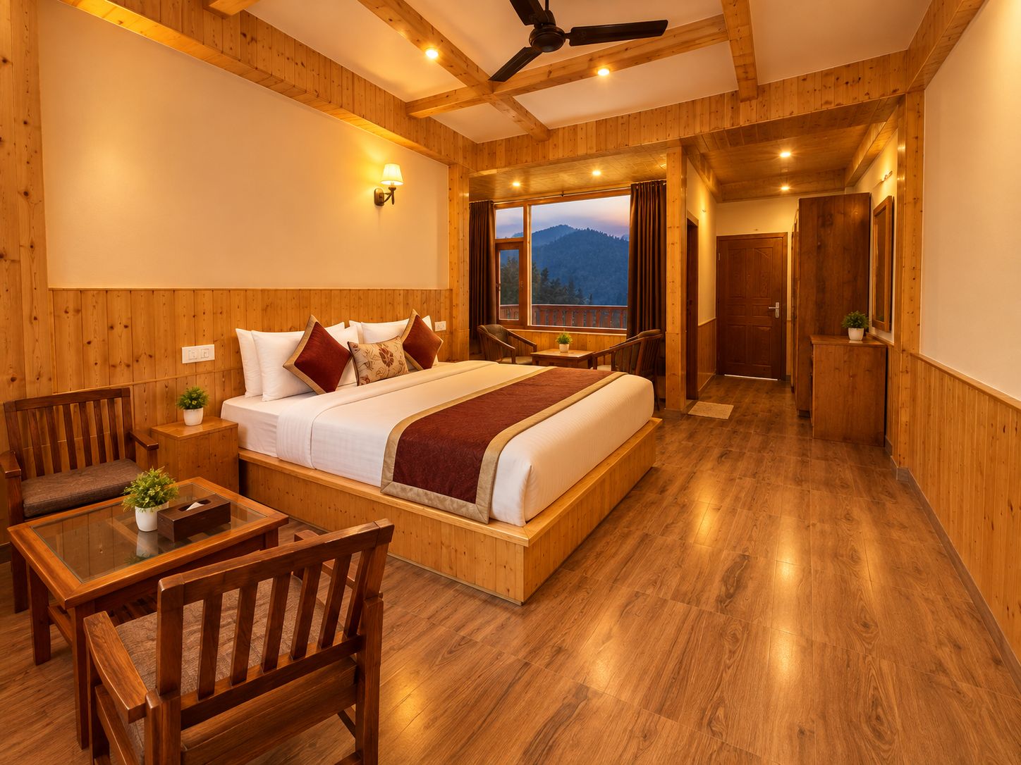 A wooden-floored bedroom with a bed, a desk, and a chair.
