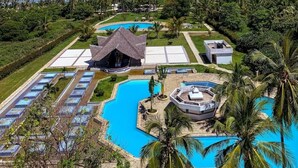 A resort with multiple swimming pools, a large central pool, and a view of the ocean. - Samara Studio Beachfront Apartment - Diani Beach (Diani Beach)