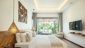 A modern bedroom with a large bed, a TV, and a view of the outdoors. - Modern 4br Villa Canggu Rice View AC (Tibubeneng)