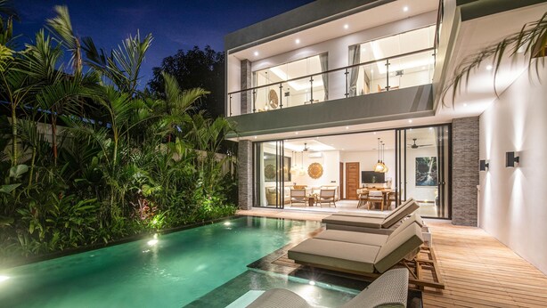 A modern two-story house with a swimming pool, outdoor furniture, and lush greenery. - Modern 4br Villa Canggu Rice View AC (Tibubeneng)