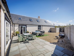 A house with a patio area, a hot tub, and a barbecue grill. - The Stables - UK52287 (Auchincruive)