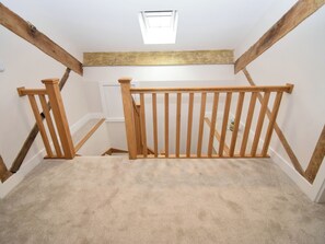 A staircase with wooden railings leading to an upper floor. - 6 bedroom accommodation in Carnforth (Carnforth)