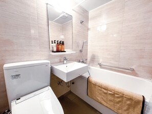 A modern bathroom with a toilet, sink, and bathtub. - LiVEMAX RESORT TSUKUBASAN (Tsukuba)