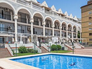 A hotel with a swimming pool, multiple balconies, and a staircase leading to the entrance. - Los Arcos by Interhome (Torremolinos)