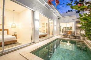 A modern interior with a glass-enclosed bedroom, a pool area, and a dining space. - Brand New 2br Uluwatu Villa 2 Mins to Beach (Pecatu)
