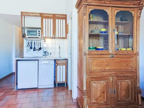 A compact kitchen with a microwave, coffee maker, and dishwasher. - L'Annonciade by Interhome (Port Cogolin)