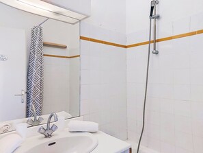 A bathroom with a sink, mirror, shower, and towel rack. - L'Annonciade by Interhome (Port Cogolin)