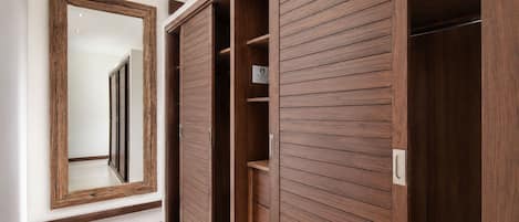 A hallway with a wooden wardrobe and a mirror.