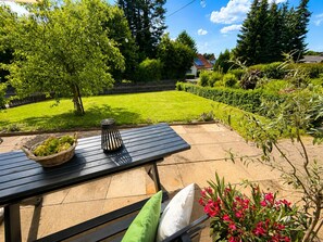 A patio with a table, a basket, and a bench with cushions. - Herzwerk Schwalenberg by Interhome (Schwalenberg)