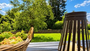 A wooden deck with a wicker basket and a metal lantern. - Herzwerk Schwalenberg by Interhome (Schwalenberg)